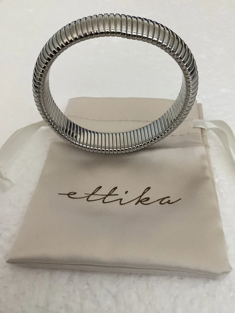 This Ettika silver-plated flexible tubogas-style stretch cuff silver tone brace